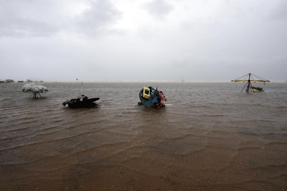 Children's joy rides are partially submerged in water at the Marina Beach on the Bay of Bengal coast in Chennai, India, Wednesday, Nov.25, 2020. India’s southern state of Tamil Nadu is bracing for Cyclone Nivar that is expected to make landfall on Wednesday. The state authorities have issued an alert and asked people living in low-lying and flood-prone areas to move to safer places. (AP Photo/R. Parthibhan)