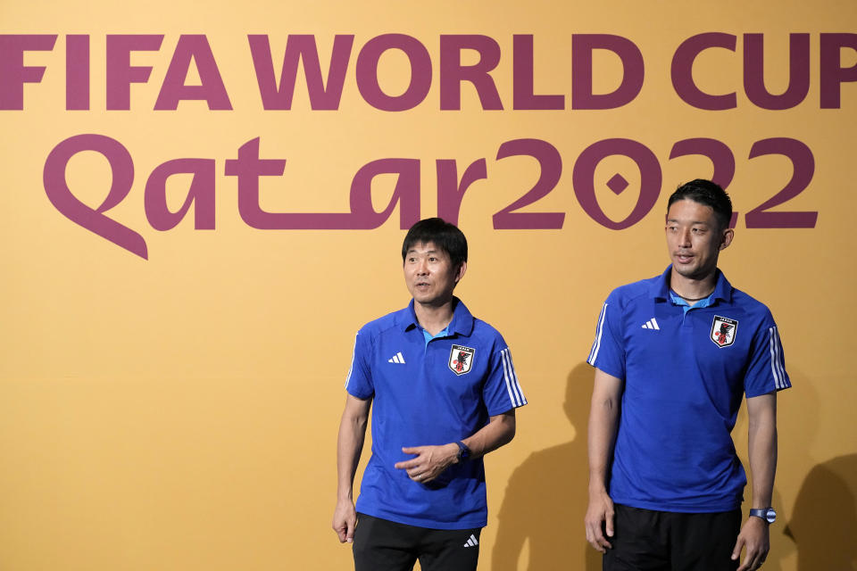 Japan's head coach Hajime Moriyasu, left, and Japan's goalkeeper Shuichi Gonda, right, relax after posing for photographers prior to Japan official press conference on the eve of the group E of World Cup soccer match between Japan and Spain, in Doha, Qatar, Wednesday, Nov. 30, 2022. (AP Photo/Eugene Hoshiko)