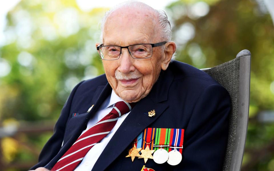 Captain Sir Tom Moore smiles as he launches his autobiography at his home in Milton Keynes - DYLAN MARTINEZ/REUTERS