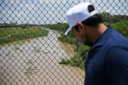 A pedestrian walks above the Rio Grande on the Mexican side of the Brownsville-Matamoros International Bridge