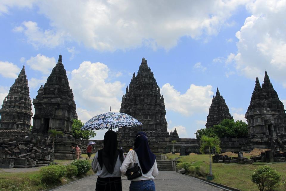 <span class="caption">Indonesia has reopened tourism after intensified vaccination campaigns have helped control the spread of COVID-19.</span> <span class="attribution"><a class="link " href="https://www.gettyimages.com/detail/news-photo/tourists-visit-one-of-the-largest-hindu-temples-in-the-news-photo/1235376076?adppopup=true" rel="nofollow noopener" target="_blank" data-ylk="slk:Feature China/Barcroft Media via Getty Images;elm:context_link;itc:0;sec:content-canvas">Feature China/Barcroft Media via Getty Images</a></span>