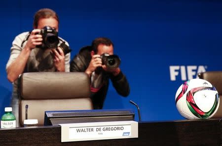 Journalists take pictures before a news conference of Walter De Gregorio, FIFA Director of Communications and Public Affairs at FIFA headquarters in Zurich, Switzerland, May 27, 2015. REUTERS/Ruben Sprich