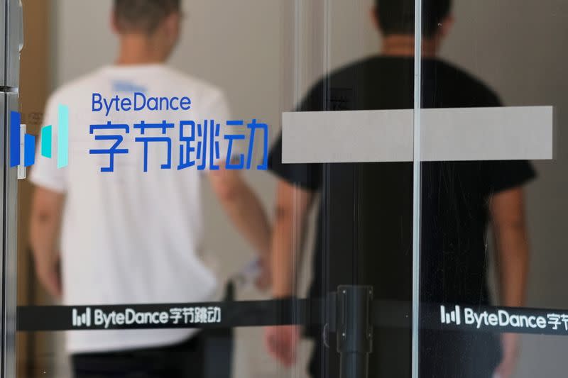 FILE PHOTO: People walk past a logo of Bytedance, which owns short video app TikTok, at its office in Beijing