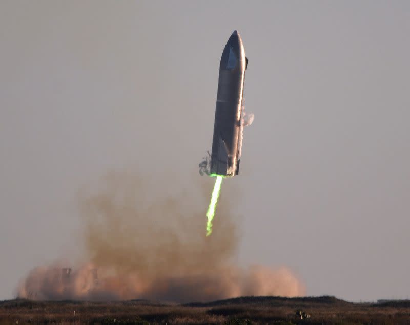 FILE PHOTO: SpaceX's first super heavy-lift Starship SN8 rocket prepares to land after it launched from their facility on a test flight in Boca Chica, Texas