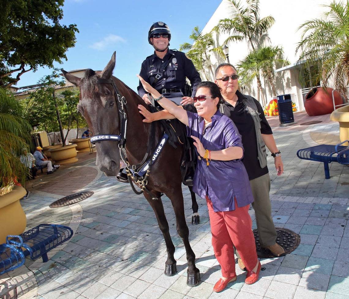 A tourist checks out Officer Eduardo Perez and his horse Panchito of the City of Miami Mounted Police at Domino Park on Friday June 13, 2014.