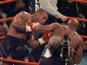 <p>Evander Holyfield, right, delivers a punch to Mike Tyson in the first round of their WBA Heavyweight match Saturday, June 28, 1997, at the MGM Grand in Las Vegas. (AP Photo/Jack Smith) </p>