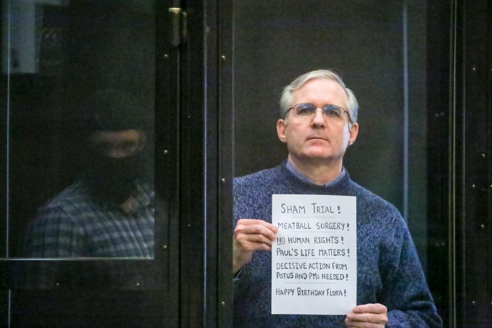 Paul Whelan holds up a message to supporters in a Moscow courtroom on June 15, 2020.