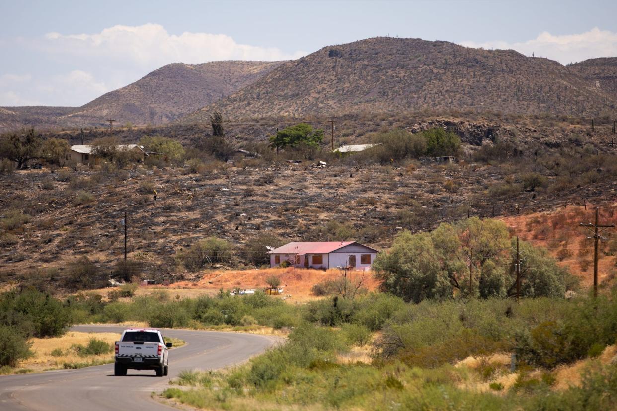 A San Carlos police vehicle drives in to areas damaged by the Watch Fire on July 13, 2024, in San Carlos, Ariz.