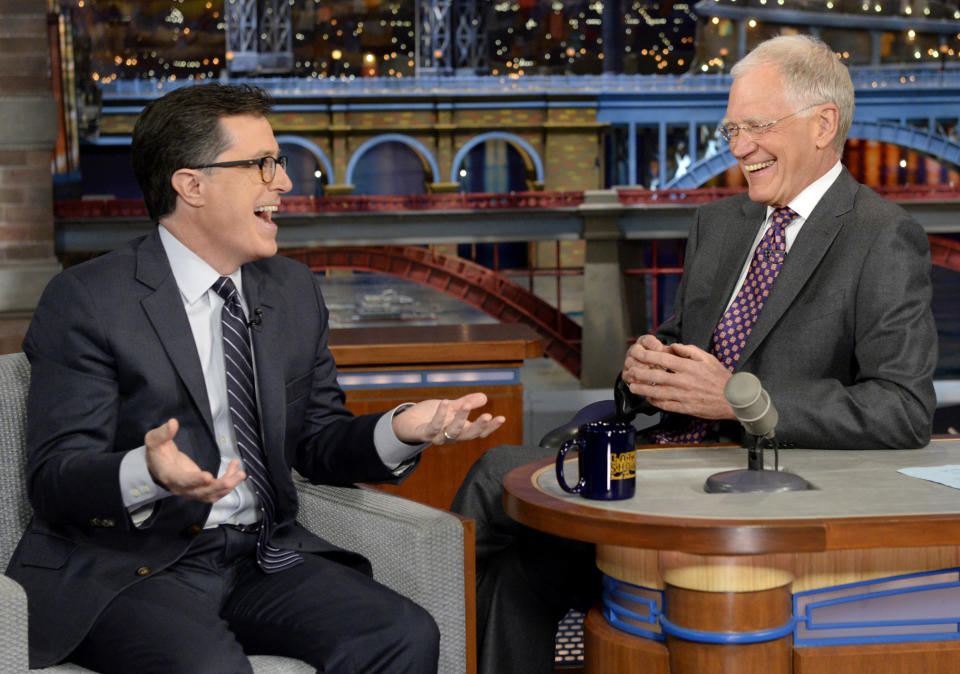 In this photo provided by CBS, Comedy Central’s Stephen Colbert, left, joins host David Letterman on the set of the “Late Show with David Letterman,” Tuesday, April 22, 2014, in New York. This was Colbert’s first visit to the show since CBS announced that he will succeed Letterman as host when he retires in 2015. (AP Photo/Jeffrey R. Staab) MANDATORY CREDIT, NO SALES, NO ARCHIVE, FOR NORTH AMERICAN USE ONLY