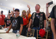 Supporters and members of Bikers for Trump wave and cheer, Saturday, Aug. 11, 2018, in the ballroom of Trump National Golf Club in Bedminster, N.J, during a meeting with President Donald Trump. (AP Photo/Carolyn Kaster)