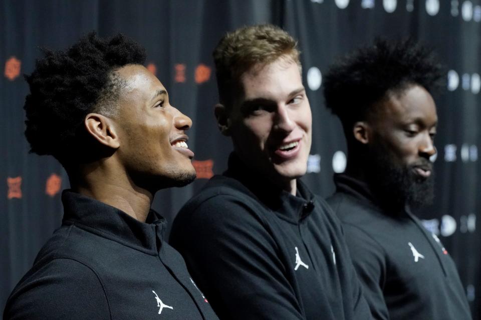 Cincinnati's Ody Oguama, left speaks while Viktor Lakhin, center, and John Newman III look on during the NCAA college Big 12 men's basketball media day Wednesday, Oct. 18, 2023, in Kansas City, Mo.