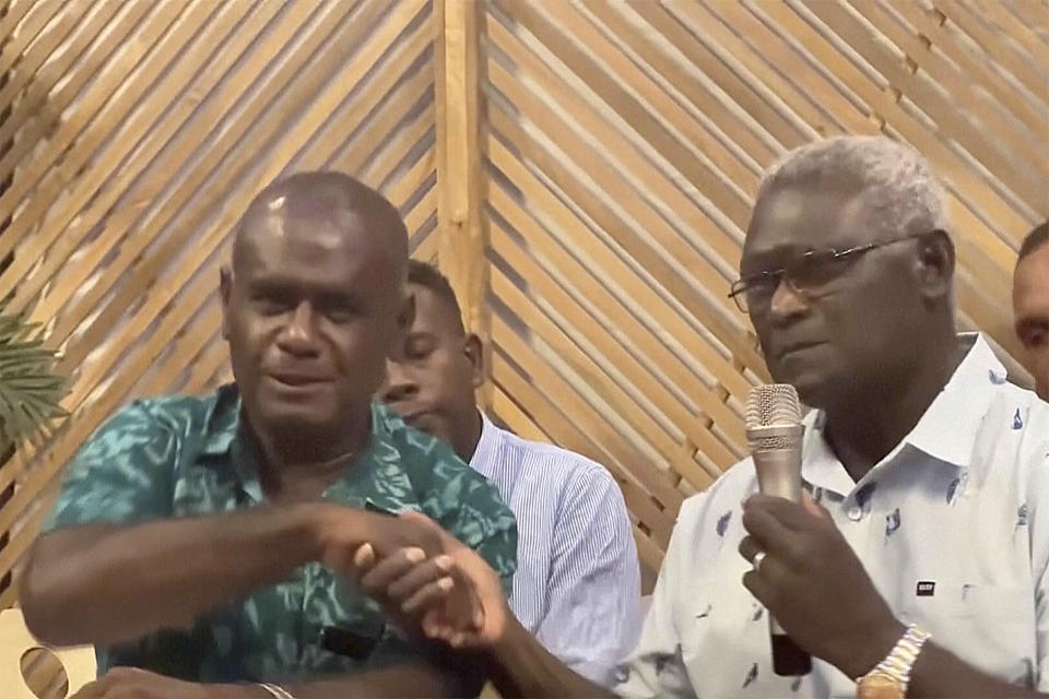 Outgoing Solomon Islands Prime Minister Manasseh Sogavare, right, and candidate for prime minister Jeremiah Manele shake hands during a news conference, Monday, April 29, 2024, in Honiara, Solomon Islands. Sogavare on Monday withdrew from the contest to remain head of the strategically important South Pacific island nation’s government following general elections two weeks ago that are central to the U.S.-China rivalry in the region. (Australian Broadcasting Corporation via AP)