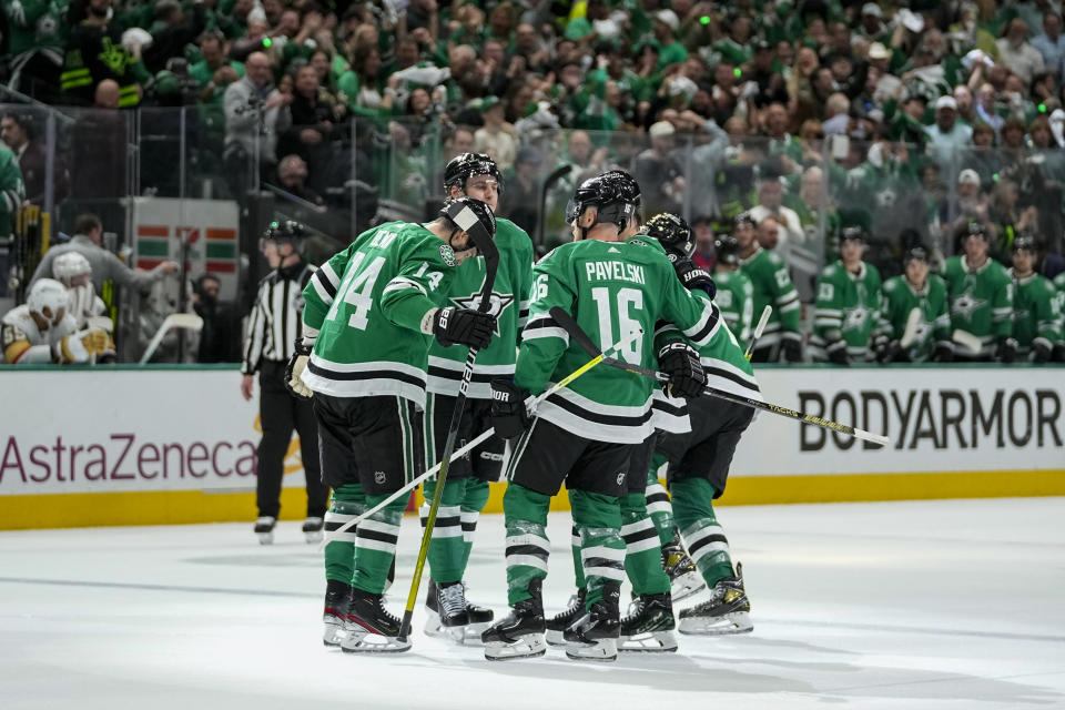 Dallas Stars players celebrate a first period power play goal by Jason Robertson, not visible, during Game 2 of an NHL hockey Stanley Cup first-round playoff series against the Vegas Golden Knights in Dallas, Wednesday, April 24, 2024. (AP Photo/Tony Gutierrez)