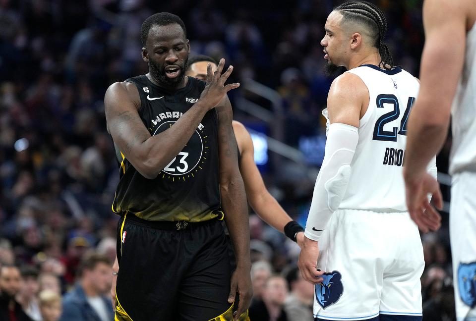 Draymond Green and Dillon Brooks exchange words with each other during a game in December.
