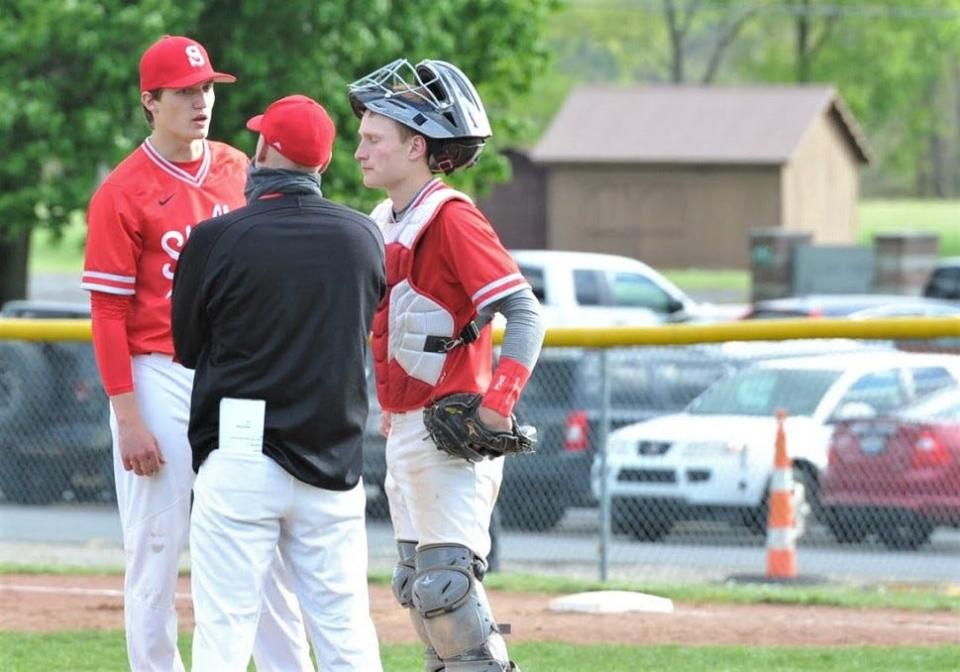 Shelby's Marshall Shepherd talks things over with head coach Jon Amicone and catcher Blaine Bowman during a game at Clear Fork. Shepherd was named the 2021 Mansfield News Journal Baseball Pitcher of the Year.