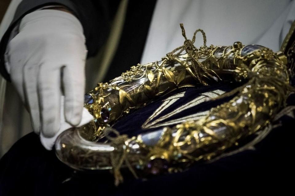 A priest wipes the Crown of Thorns, a relic of the passion of the Christ - at Notre Dame Cathedral (Picture: AFP/Getty)