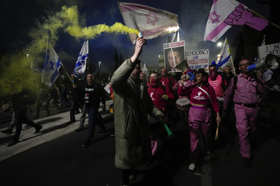 FILE - Israelis protest against plans by Prime Minister Benjamin Netanyahu's new government to overhaul the judicial system, near the Knesset, Israel's parliament in Jerusalem, Monday, Feb. 20, 2023. (AP Photo/Ohad Zwigenberg, File)