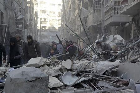 Residents inspect damage after airstrikes by pro-Syrian government forces in the rebel held Al-Shaar neighborhood of Aleppo, Syria February 4, 2016. REUTERS/Abdalrhman Ismail