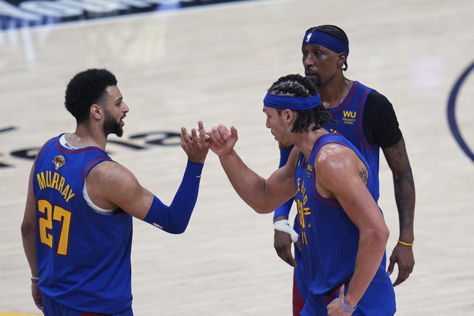 Denver Nuggets guard Jamal Murray, left, and forward Aaron Gordon, front right, celebrate after Game 1 of the basketball team's NBA Finals against the Miami Heat, Thursday, June 1, 2023, in Denver. (AP Photo/Jack Dempsey)