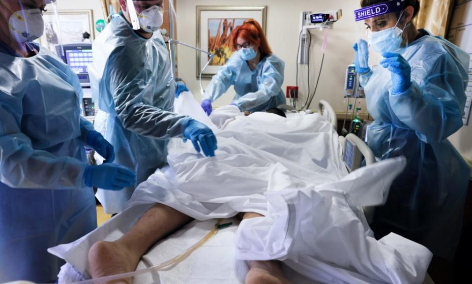 Clinicians prepare to re-position a COVID-19 patient at Providence St. Mary Medical Center amid a surge in coronavirus patients at the hospital and across Southern California. (Photo by Mario Tama/Getty Images)