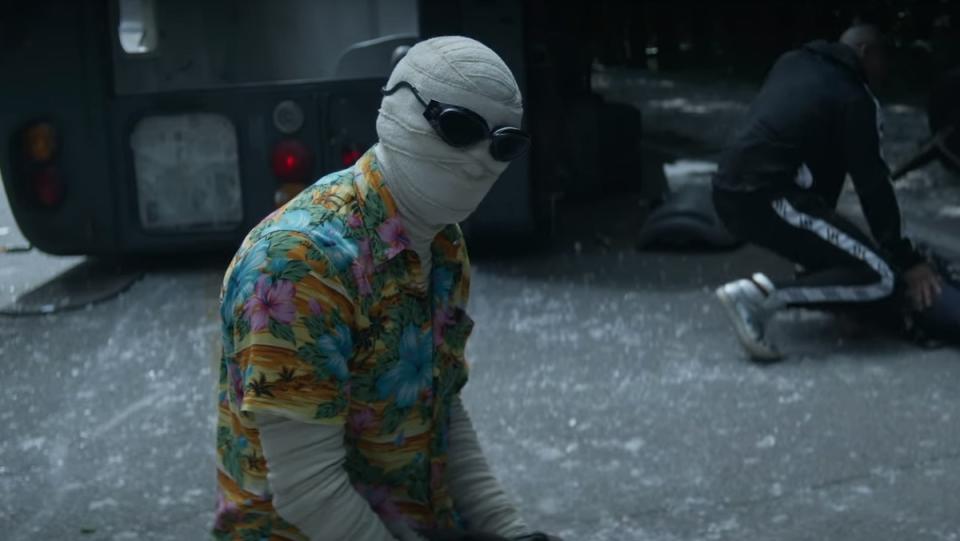 Mr. Negative wears a Hawaiian shirt and looks very sad and despondent while Cyborg crouches in the background in the season three trailer for Doom Patrol.