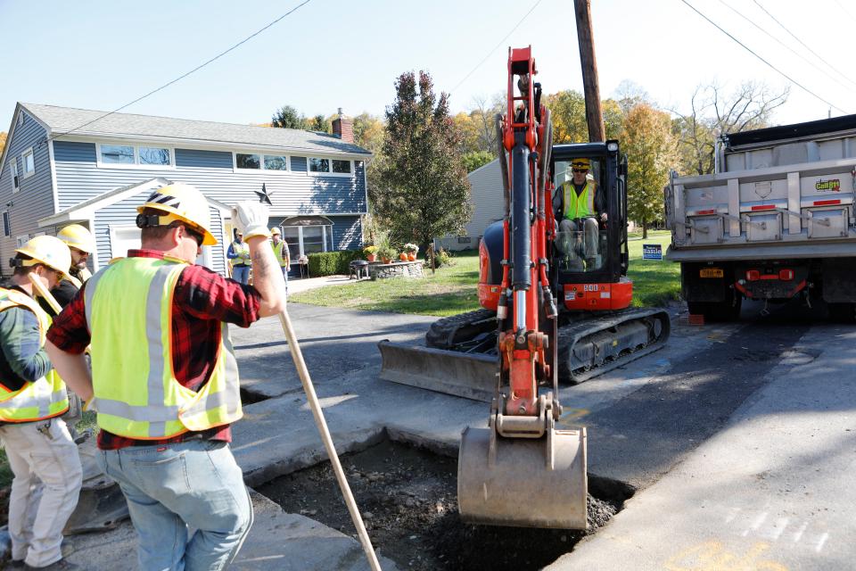 Workers with Central Hudson Gas and Electric Corp finish up hooking up a residence to a newly installed upgraded gas main in Cornwall on Oct. 31, 2018. The new mains are made of polyethylene plastic and replaces cast iron lines.  All houses connected to the old lines are required to be upgraded to match the new lines.