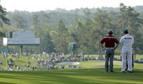 Louis Oosthuizen, of South Africa, and his caddie Wynand Stander look over the second fairway during the second round of the Masters golf tournament Friday, April 11, 2014, in Augusta, Ga. (AP Photo/David J. Phillip)