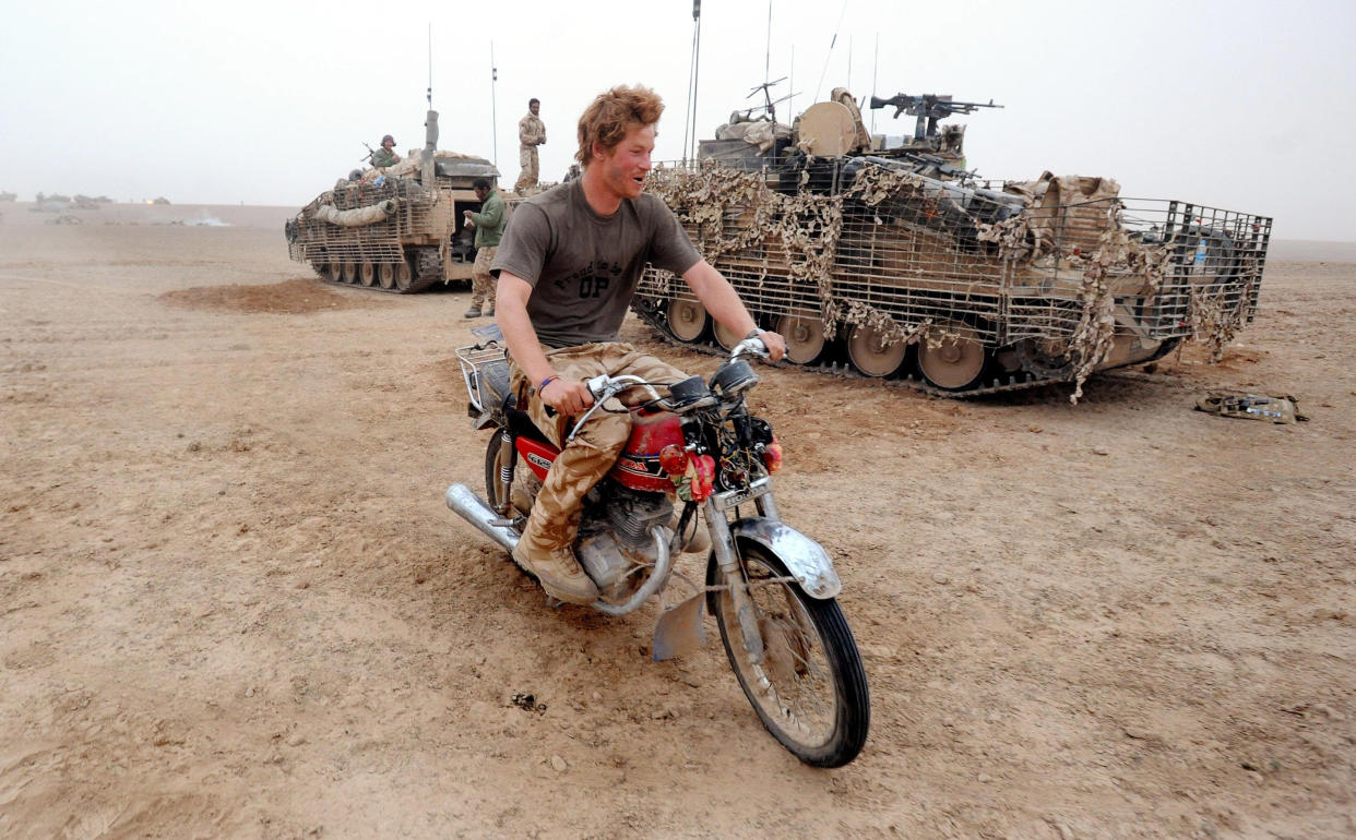 HELMAND PROVINCE- FEBRUARY 21: (NO PUBLICATION IN UK MEDIA FOR 28 DAYS)  Prince Harry tries to start an abandoned motorcycle in the desert on February 21, 2008 in Helmand Province, Afghanistan.  (Photo by John Stillwell - POOL/Anwar Hussein Collection/WireImage)