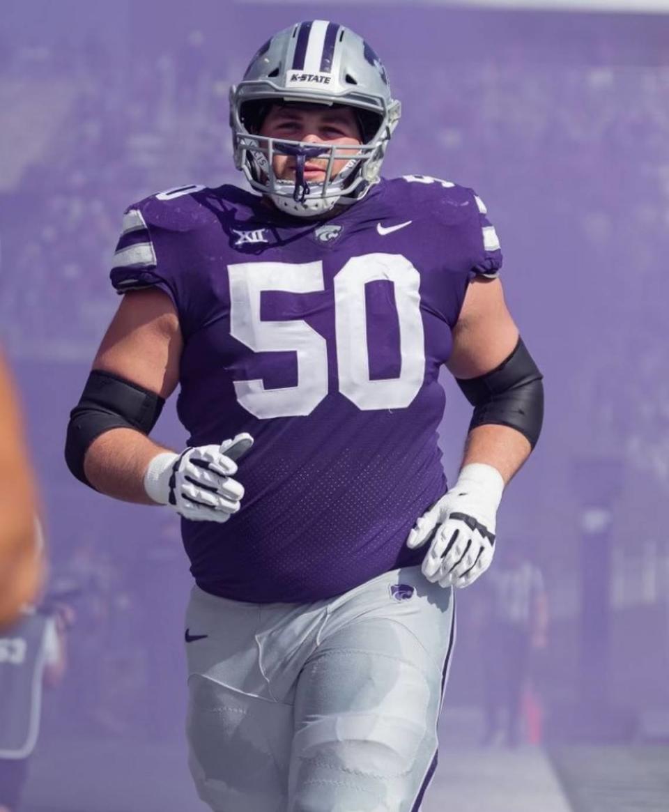 Kansas State offensive lineman Cooper Beebe jogs onto the football field at Bill Snyder Family Stadium.