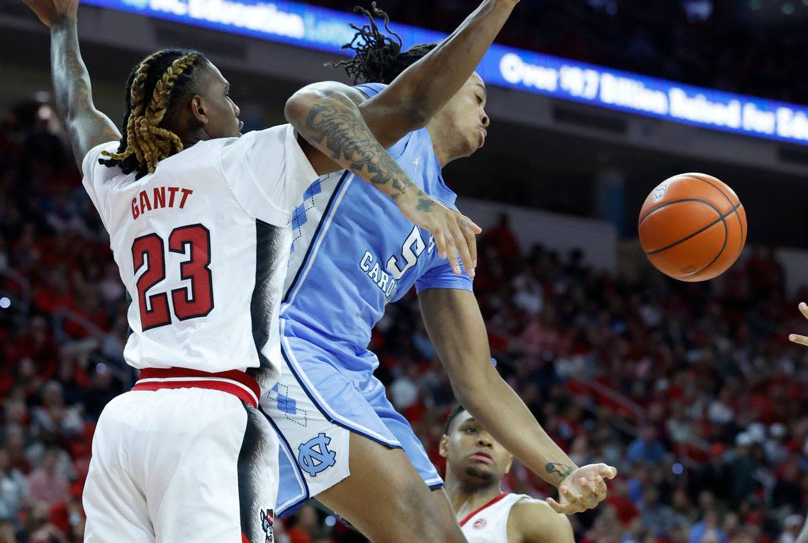 North Carolina’s Armando Bacot (5) and N.C. State’s Greg Gantt (23) battle for the ball during the first half of N.C. State’s game against UNC at PNC Arena in Raleigh, N.C., Sunday, Feb. 19, 2023.