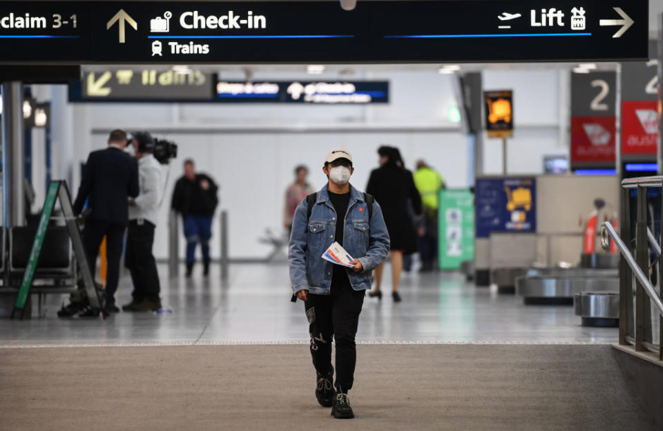 Passengers wearing face masks at Sydney Airport after arriving on a Jetstar flight. Source: Getty