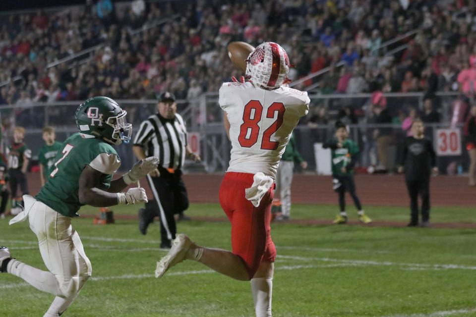 Port Clinton's Adam Thorbahn catches a touchdown as Oak Harbor's Jaqui Hayward defends.