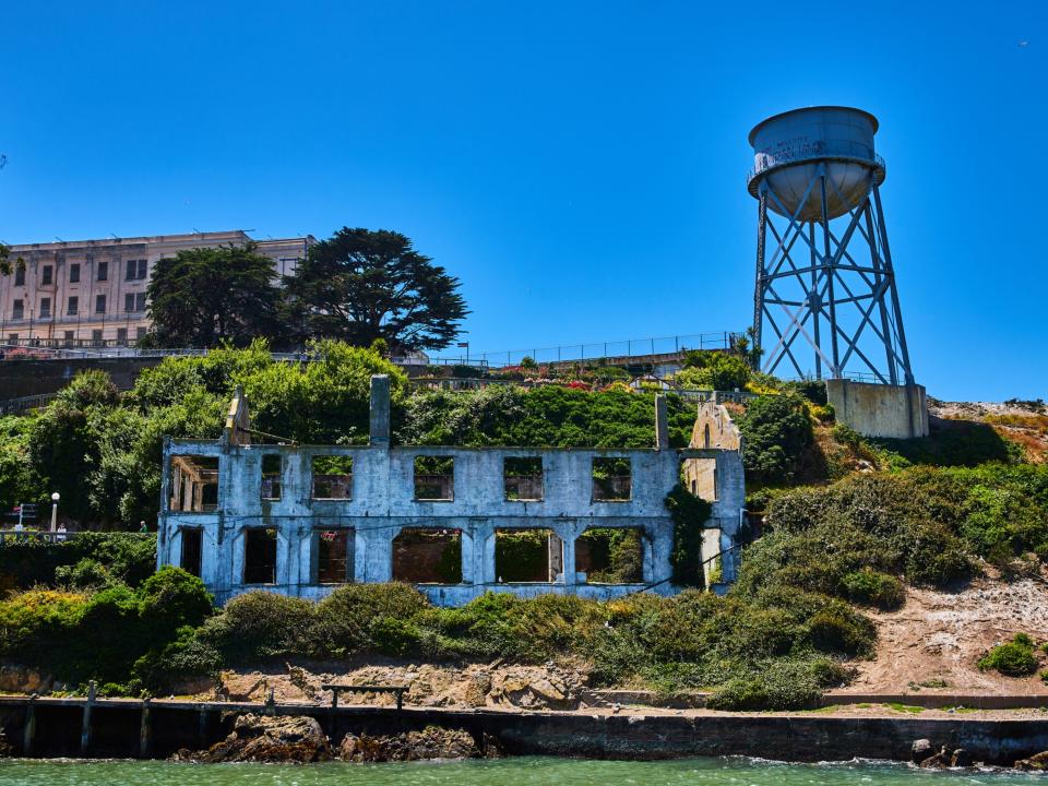 Close up view of Alcatraz Island with abandoned building and water tower.