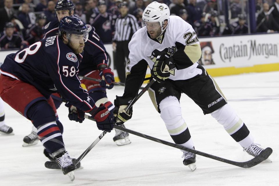 Pittsburgh Penguins' Lee Stempniak, right, tries to carry the puck past Columbus Blue Jackets' David Savard during the first period of Game 4 of a first-round NHL hockey playoff series on Wednesday, April 23, 2014, in Columbus, Ohio. (AP Photo/Jay LaPrete)