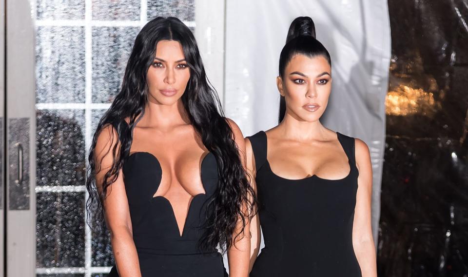 kim and kourtney kardashian wearing black dresses
