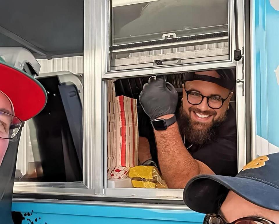 Banzito’s Tacos owner Adam Saldaña peeks out of the window of his taco truck.