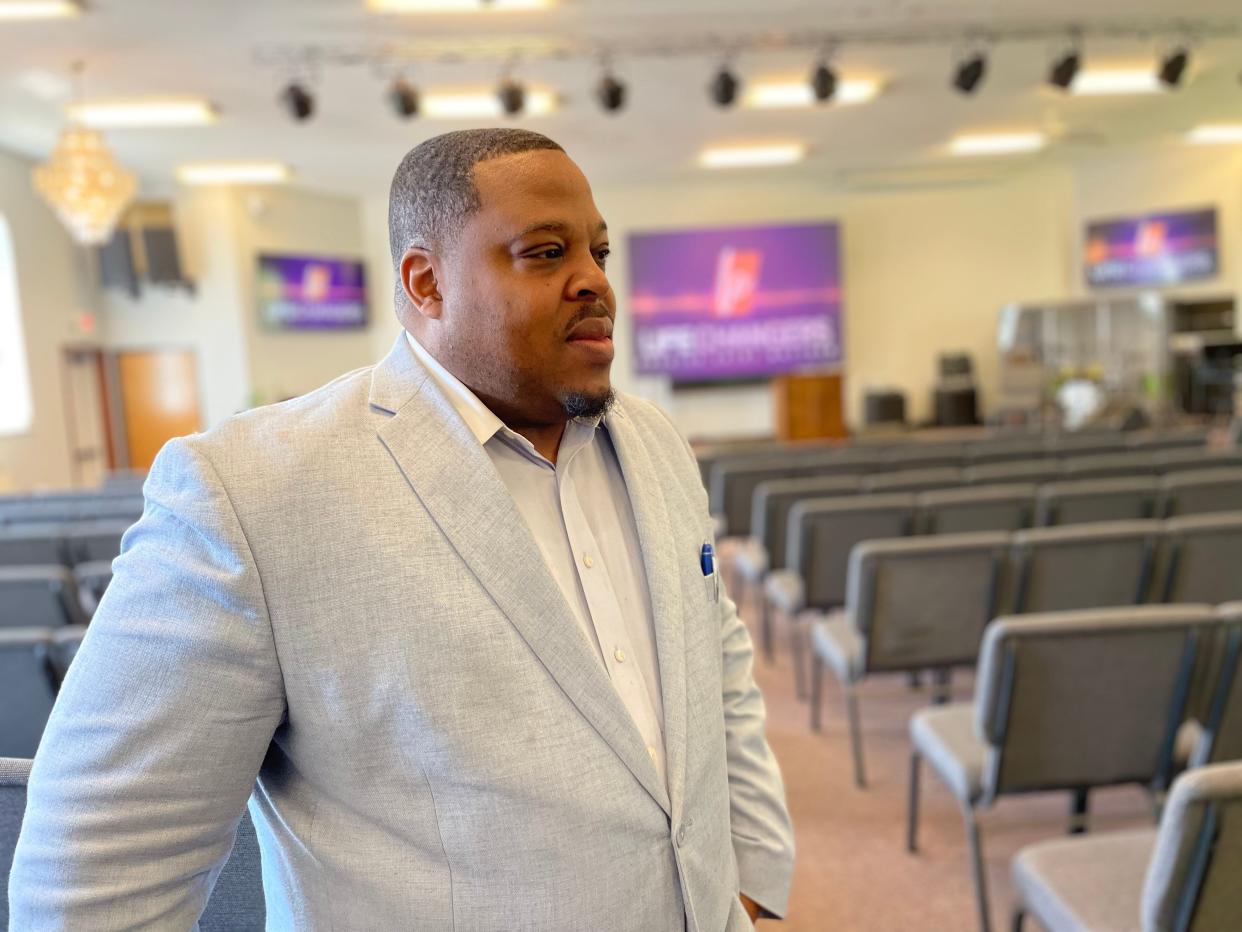 The Rev. Charles King stands in the sanctuary of Greater St. Matthew Church on South Bend's northwest side, where he's been a pastor for nearly 25 years.