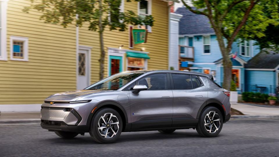 2024 chevrolet equinox ev driving down a small town street