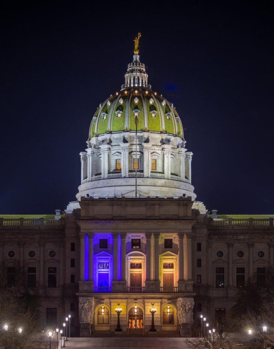The Pennsylvania State Capitol Building is lit with blue and yellow lights to symbolize the state's support for Ukraine.