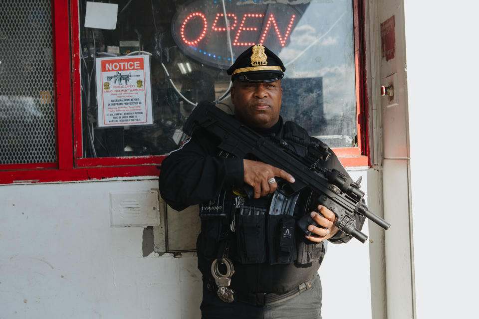 Andre Boyer stands for a portrait while patrolling a Karco gas station armed with a Bullpup shotgun.<span class="copyright">Michelle Gustafson for TIME</span>