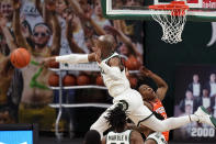 Michigan State guard Joshua Langford blocks an attempt by Illinois guard Ayo Dosunmu (11) during the second half of an NCAA college basketball game, Tuesday, Feb. 23, 2021, in East Lansing, Mich. (AP Photo/Carlos Osorio)