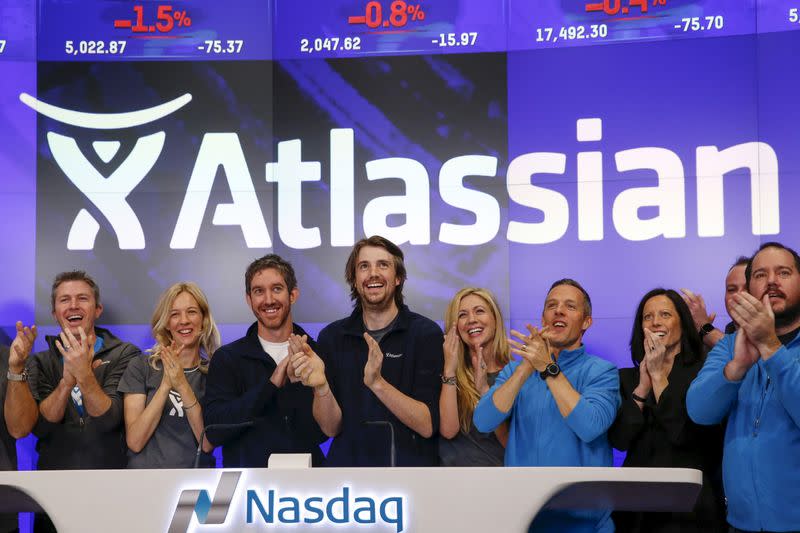 Mike Cannon-Brookes, co-founder and CEO of Atlassian Software Systems, and Scott Farquhar, co-founder and CEO of Atlassian Software Systems, smile during it's opening PO at the Nasdaq at a MarketSite in New York