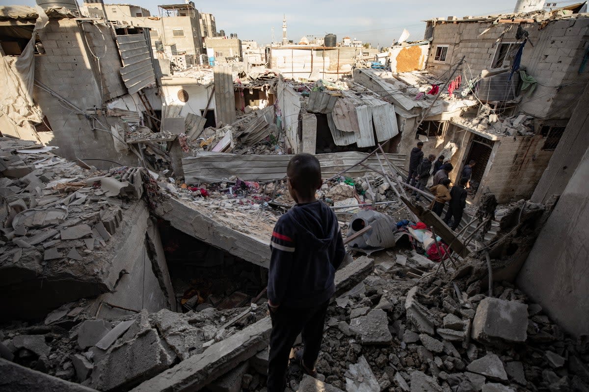 Palestinians inspect damaged areas following Israeli airstrike on Rafah, southern Gaza (EPA)