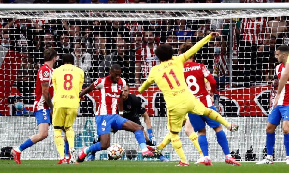 Mohamed Salah watches his shot take a deflection of a defender en route to putting Liverpool 1-0 up at Atlético Madrid