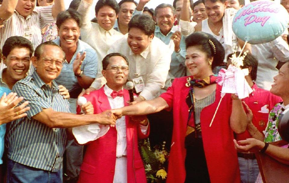Rival presidential candidates Fidel Ramos (L) and Imelda Marcos shake hands after a prayer meeting 10 May, one day before the national elections. Ramos was instrumental in ousting from power his cousin and then president Ferdinand Marcos during the 1986 people power revolution which brought Corazon Aquino to power.