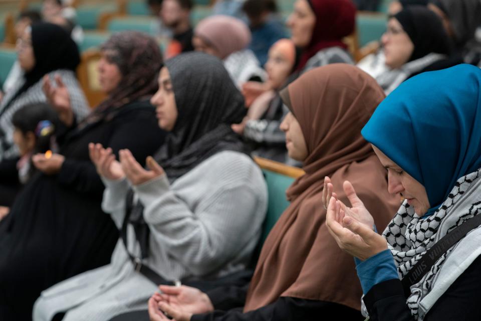 Maya Habib, of Dearborn Heights, right, holds her hands in prayer during a vigil for peace that was held at the Islamic Institute of America in Dearborn Heights on Thursday, Oct. 19, 2023.