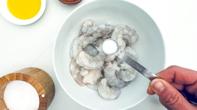 salting shrimp in bowl