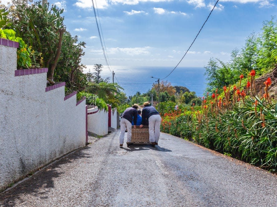 Madeira, Funchal Carreiros do Monte. Basket sledge in Madeira with a view. Cable car with ocean view.