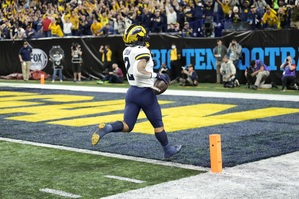 Michigan running back Blake Corum (2) scores on a 67-yard touchdown run during the first half of the Big Ten championship NCAA college football game against Iowa, Saturday, Dec. 4, 2021, in Indianapolis. (AP Photo/AJ Mast)