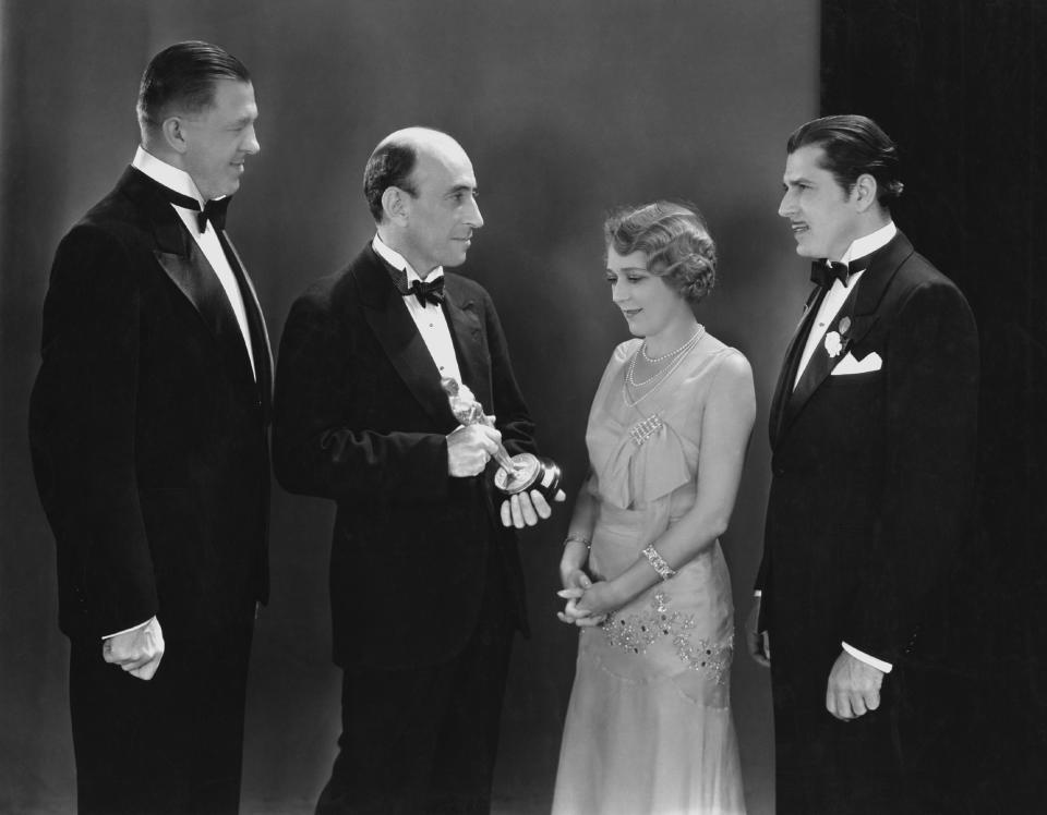 From left, Hans Kraly, winner of the Academy Award for writing; academy President William C. DeMille; best actress winner Mary Pickford; and best actor winner Warner Baxter are seen at the Oscars in Hollywood, California, April 3, 1930. / Credit: FPG/Getty Images